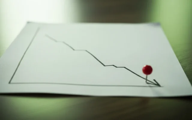 A hand-drawn downward line chart with a red pin marker, representing a ranking drop